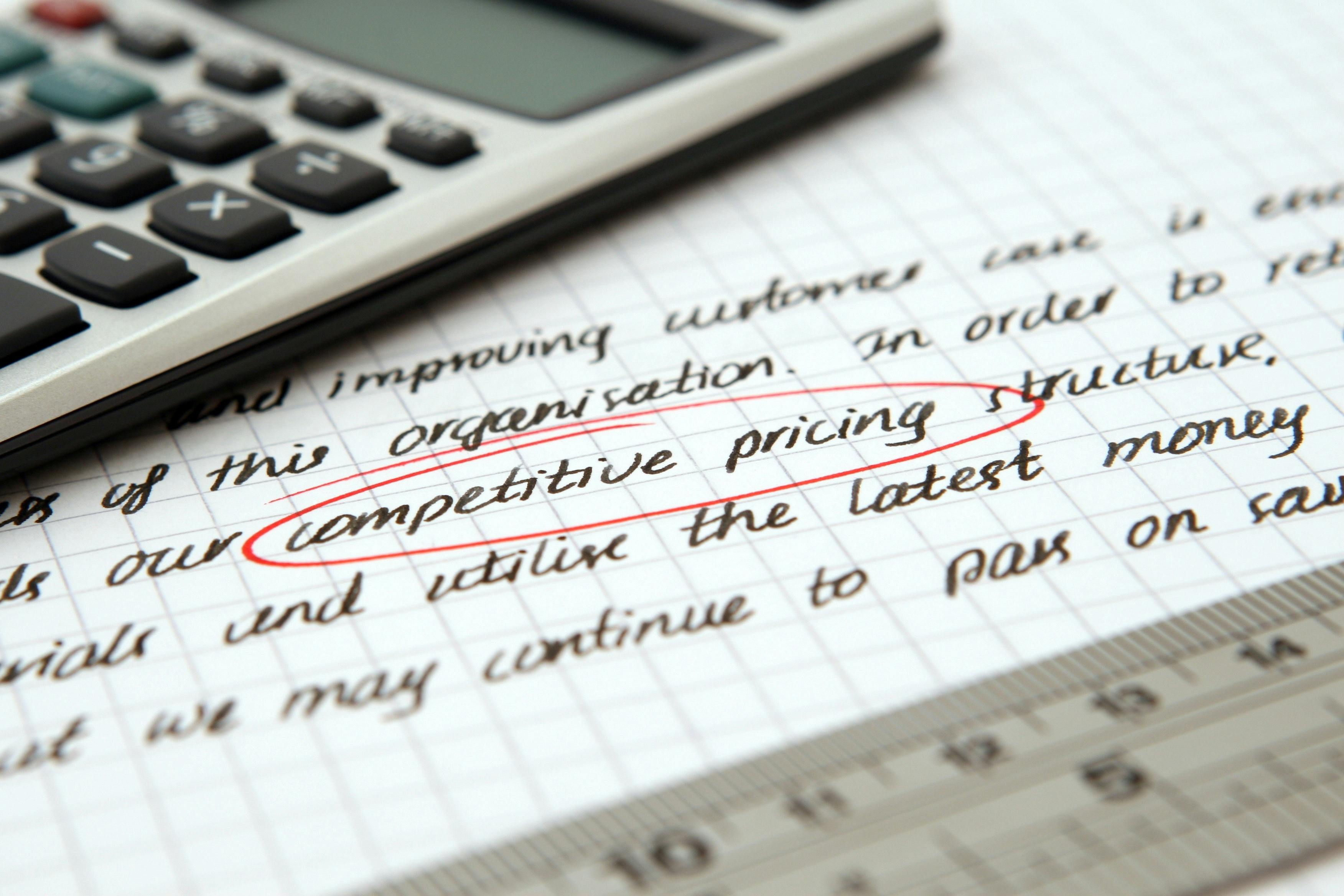 Handwritten note with competitive pricing circled with a calculator and ruler.