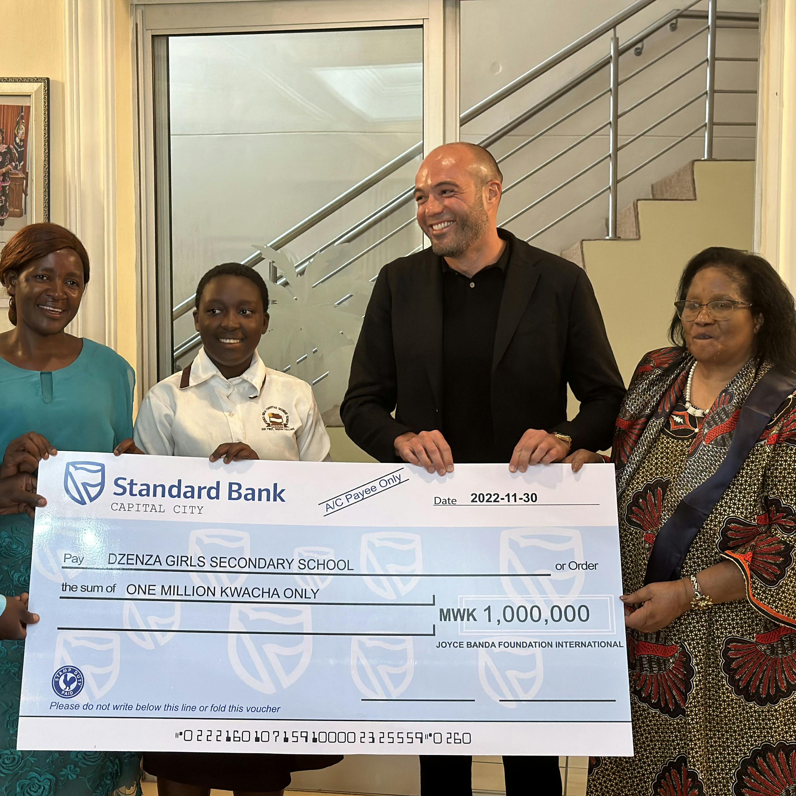 Nicholas Palahnuk presenting a donation to the Dzenza Girls Secondary School in Malawi.