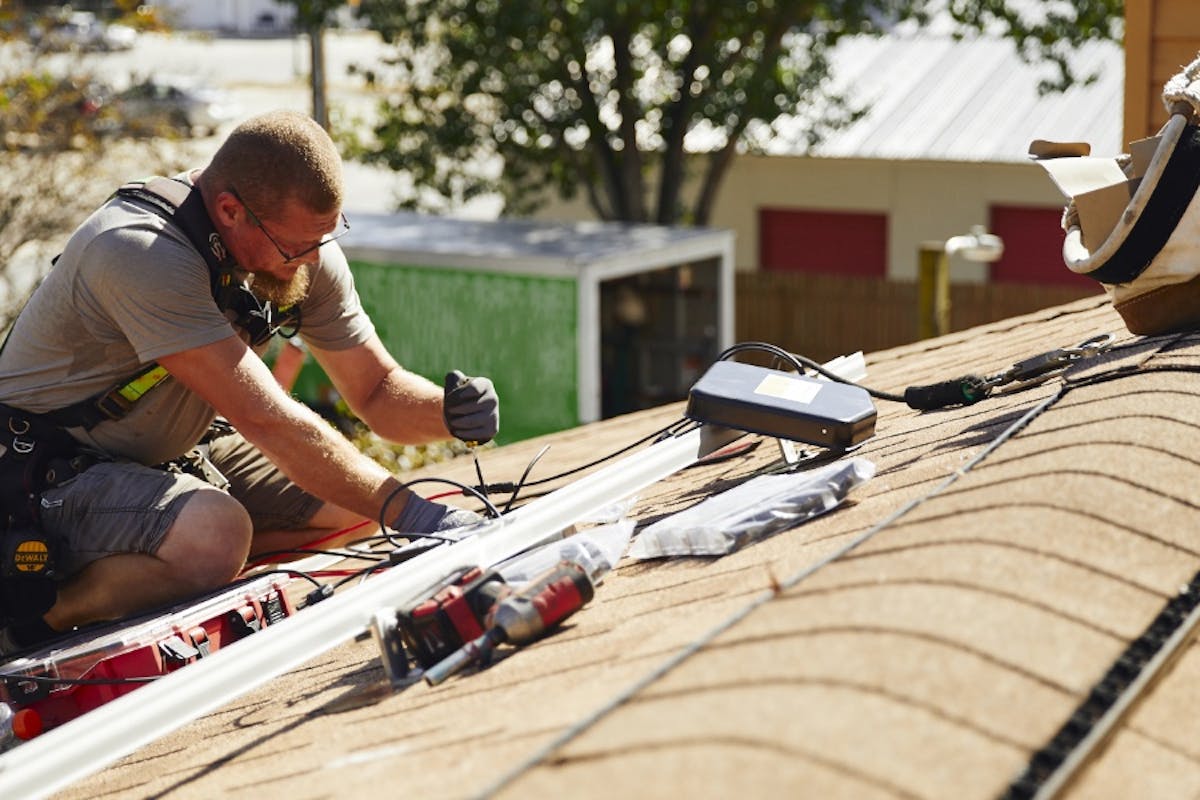 A solar service specialist works on the solar equipment of a company that has gone out of business and is no longer offering service, maintenance, or support.