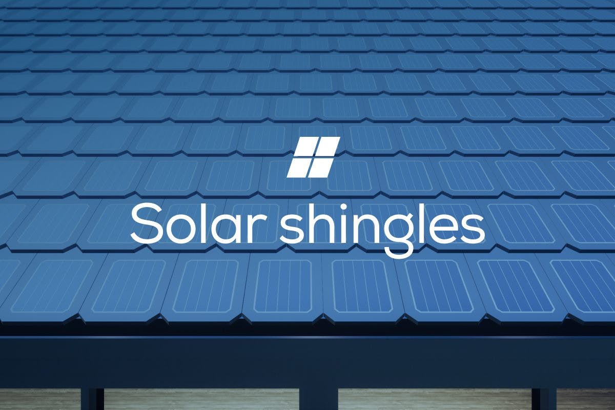 The words "Solar Shingles" over an image of a roof covered in solar shingles, representing the advantages and disadvantages of a solar shingle vs traditional solar panels, and if they’re worth the investment.