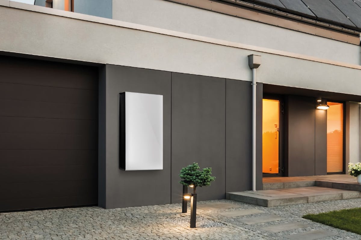 A solar battery mounted to the wall of a solar powered home to provide energy storage.