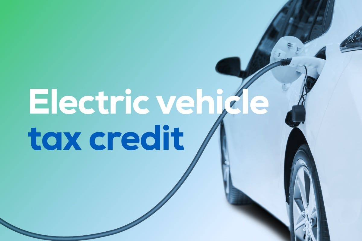 The words "electric vehicle tax credit" over an image of an electric vehicle plugged into a charger. 
