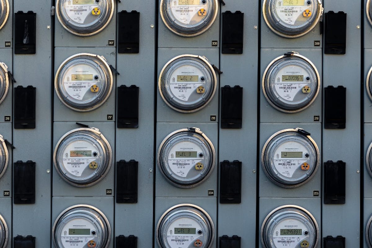 A wall of electric meters measuring electricity from the utility.