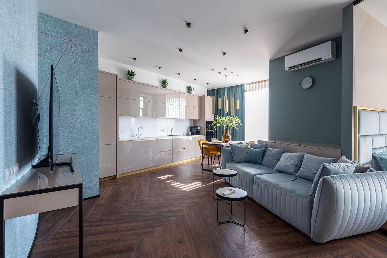 A mini-split unit high on the wall in a modern looking dining/living room.
