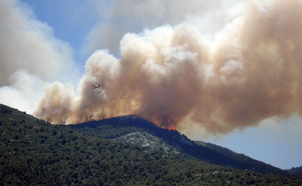 Wildfire smoke over mountains.