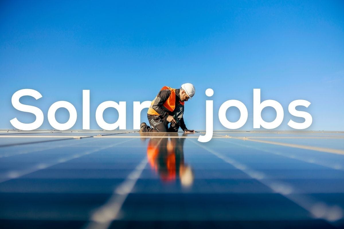 The words "Solar Jobs" over an image of a worker installing solar panels on the roof of a building.