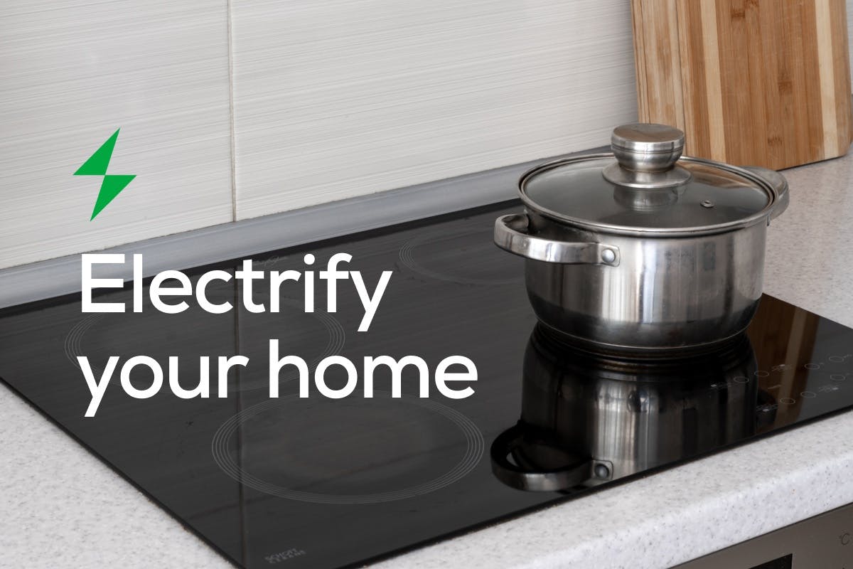 The words "Electrify your home" over an induction stove with a stainless steel pot on top. 