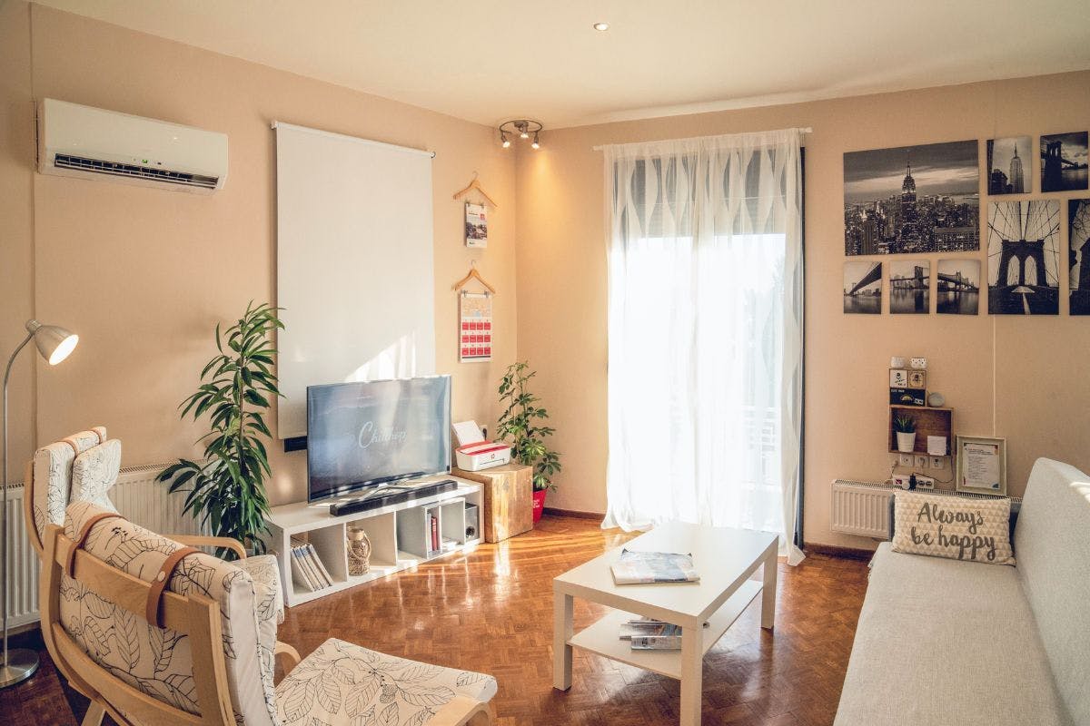 A sunlit room with a mini-split heat pump installed on the wall.