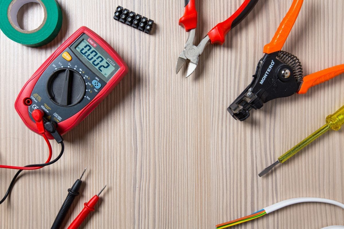 Electricians tools on a wooden surface.