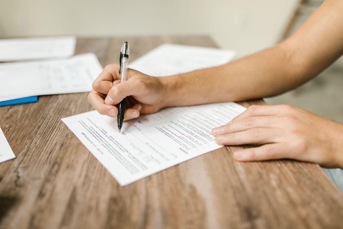 A document being signed in pen.