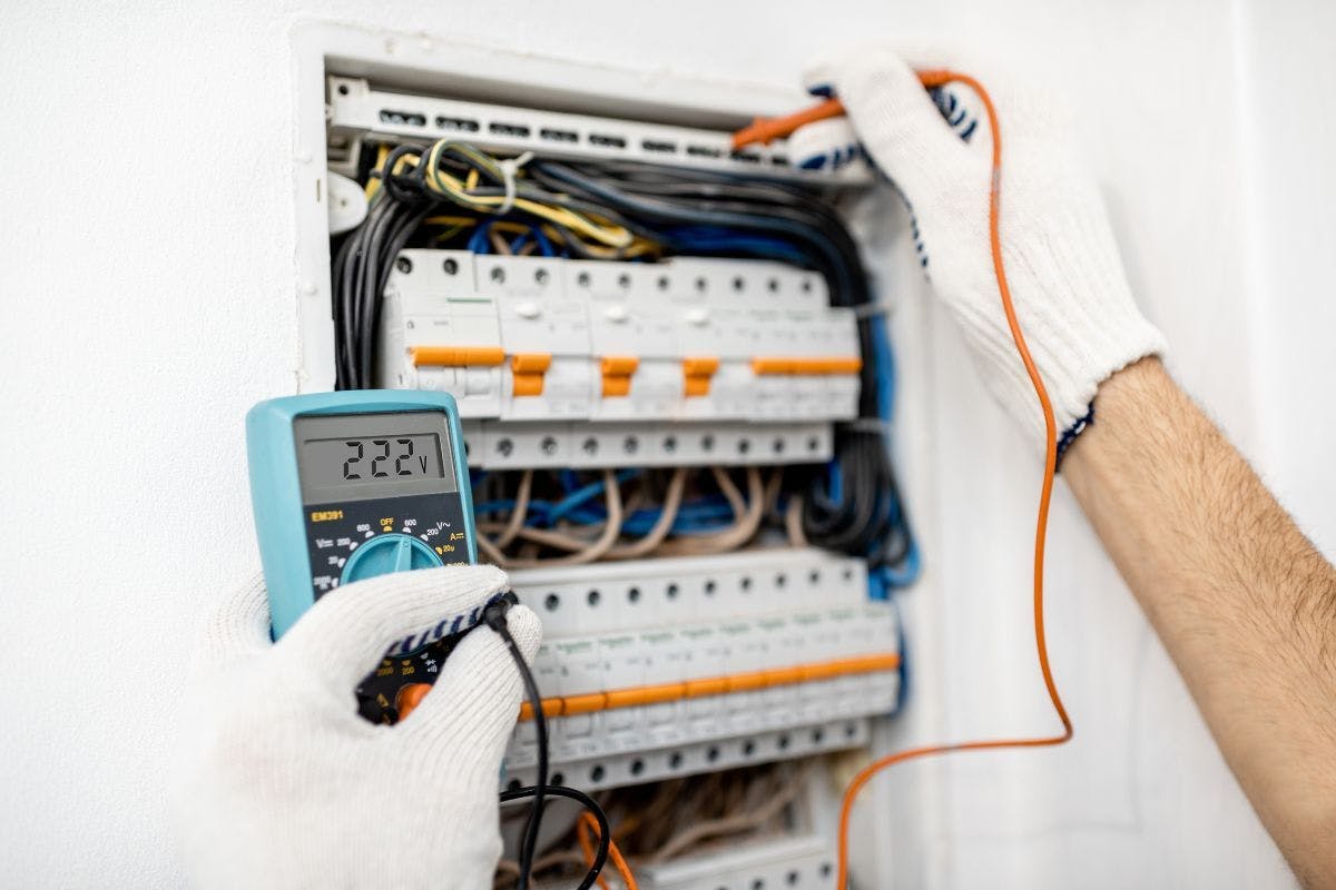 Someone working on an electrical panel.