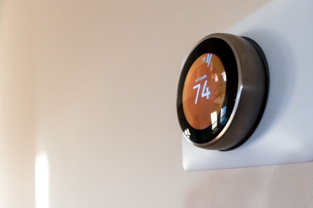 A smart thermostat on a wall.