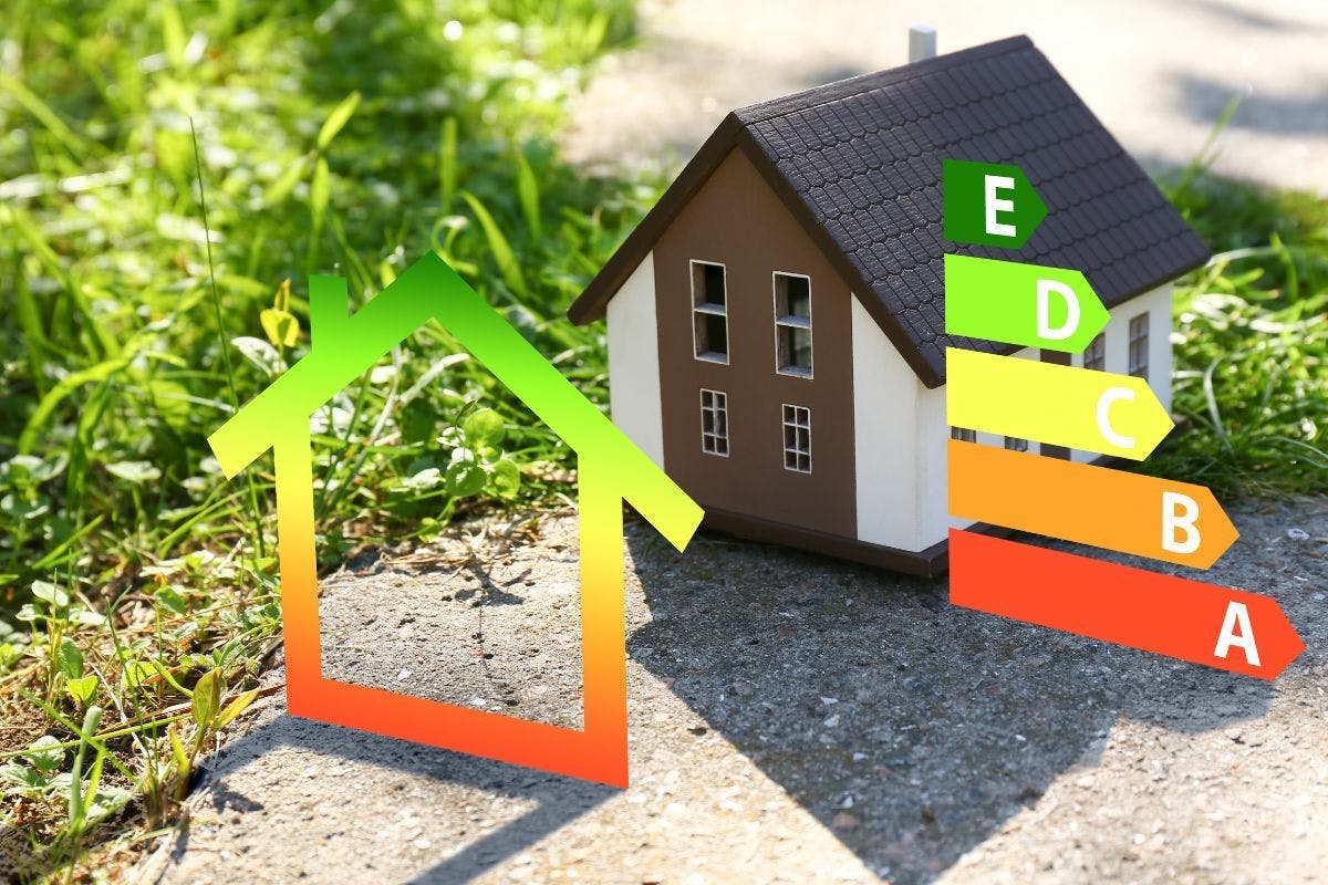 A small home with a red, yellow, and green bar graph suggesting energy use.