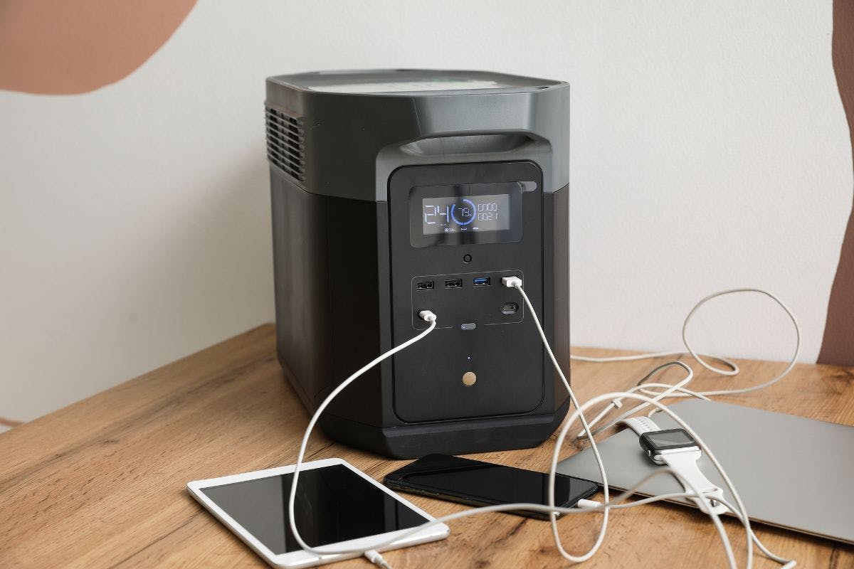 A portable power station charging devices inside a home.