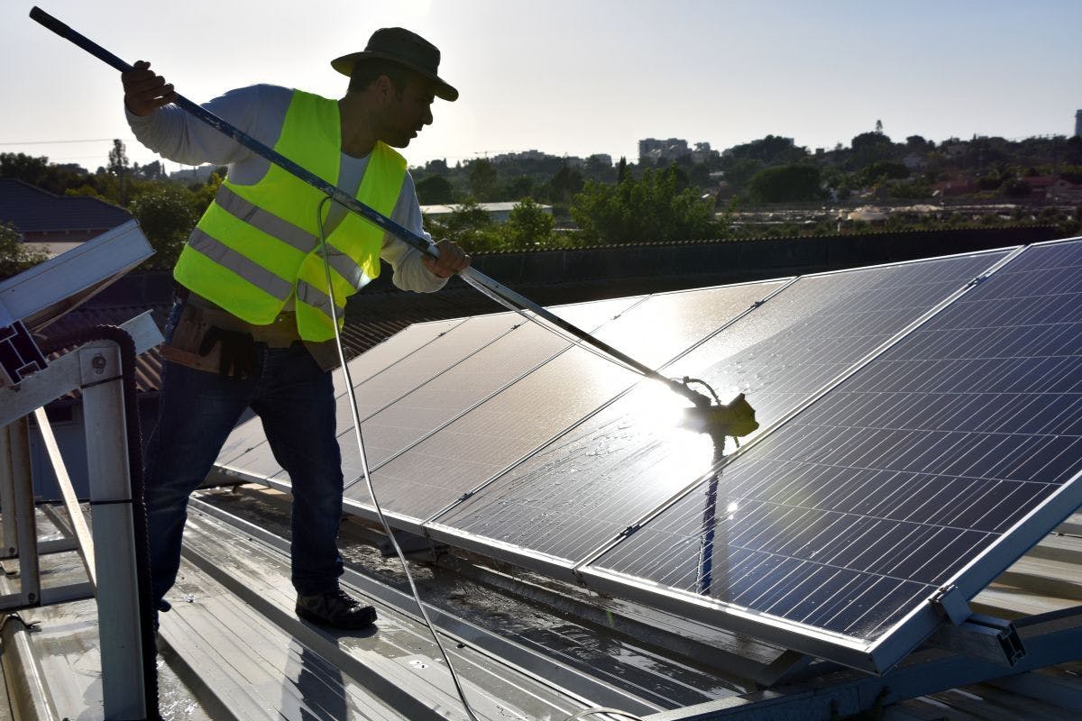 Solar panel cleaning on a roof.