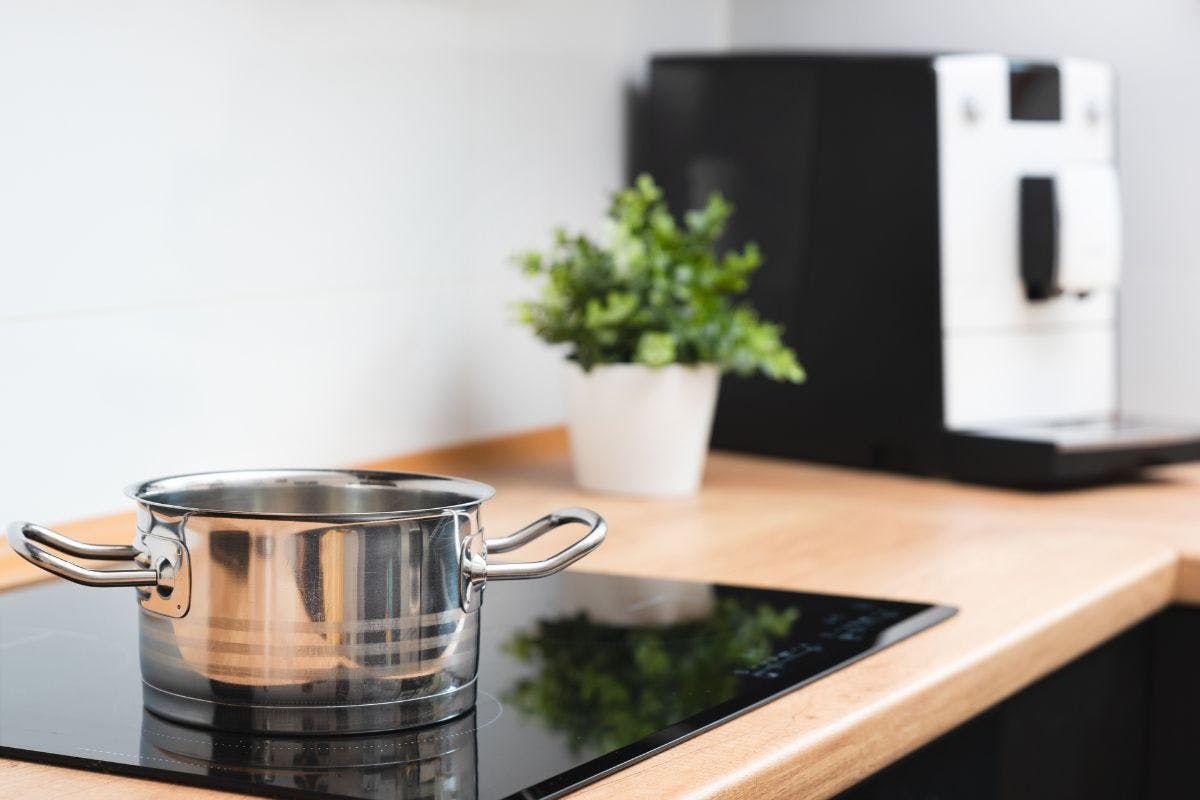 An electric cooktop in a warmly lit kitchen.