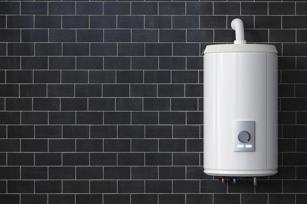 A water heater against a brick wall.