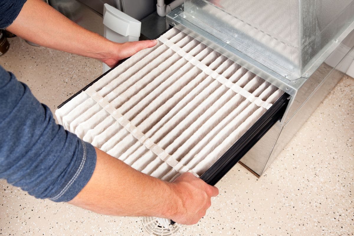 Changing an air filter in an HVAC system.