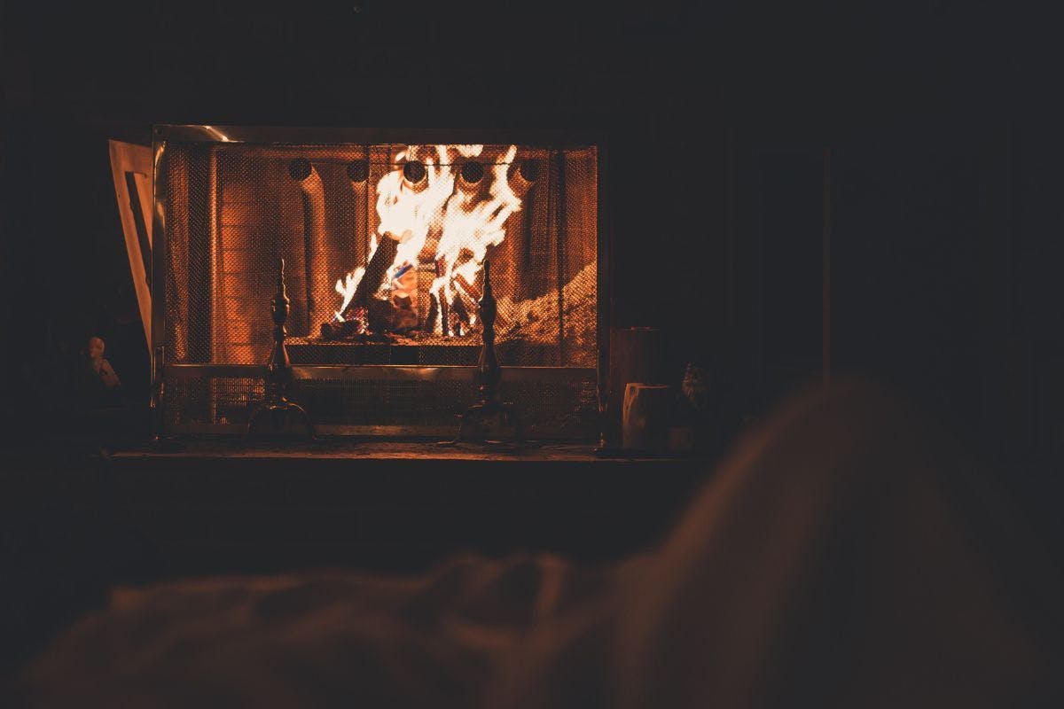 A lit fireplace indicating home heating.