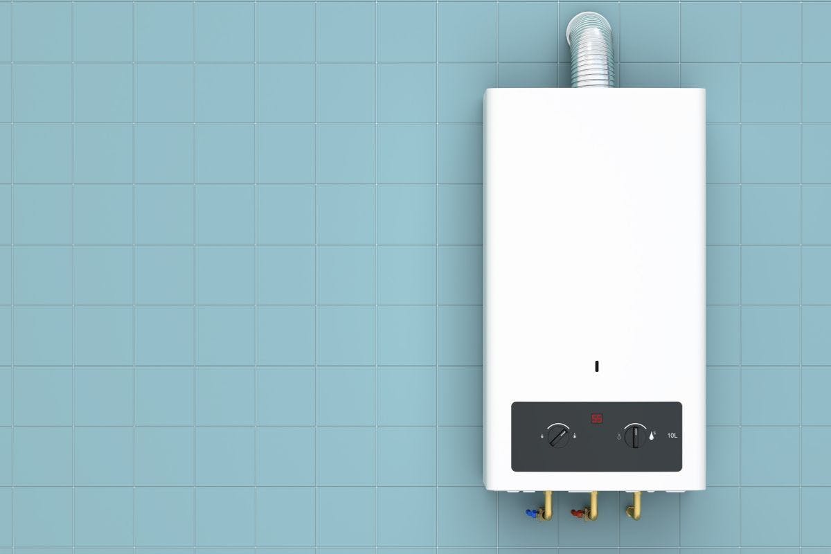 A white tankless water heater on a blue wall.
