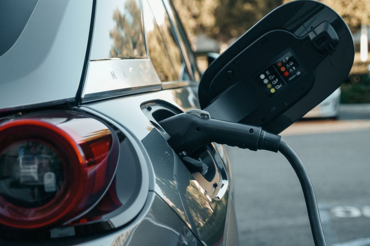 An electric vehicle with an ev charger plugged in.