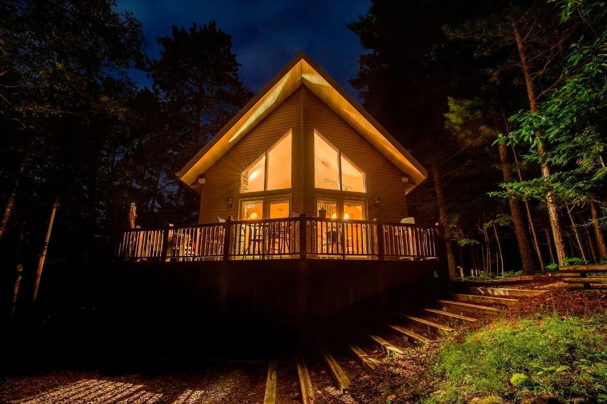 A home in the dark with its lights on.