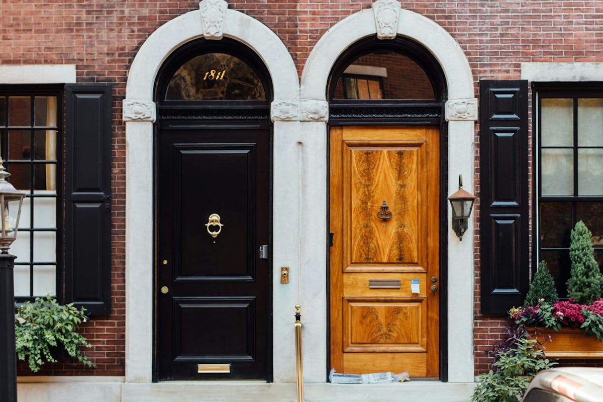 Two wooden doors in a brick building.