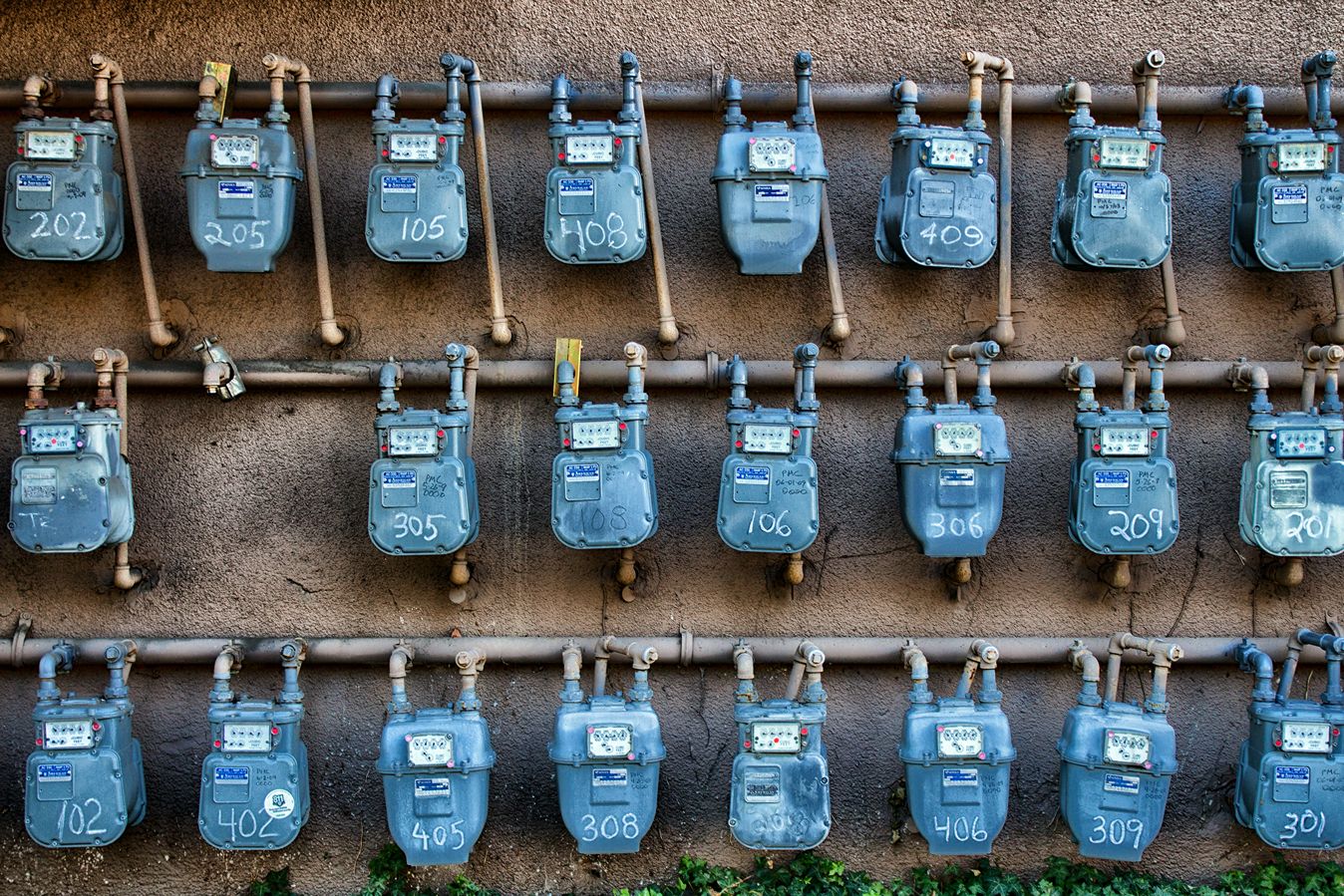 Utility meters in rows on an exterior wall.