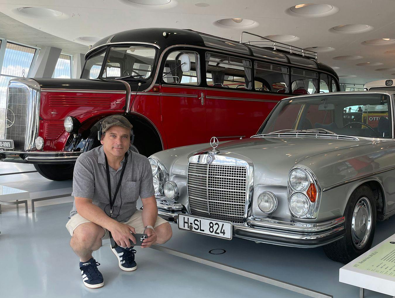 Eduardo Berlin in a museum in front of an old Mercedes-Benz.