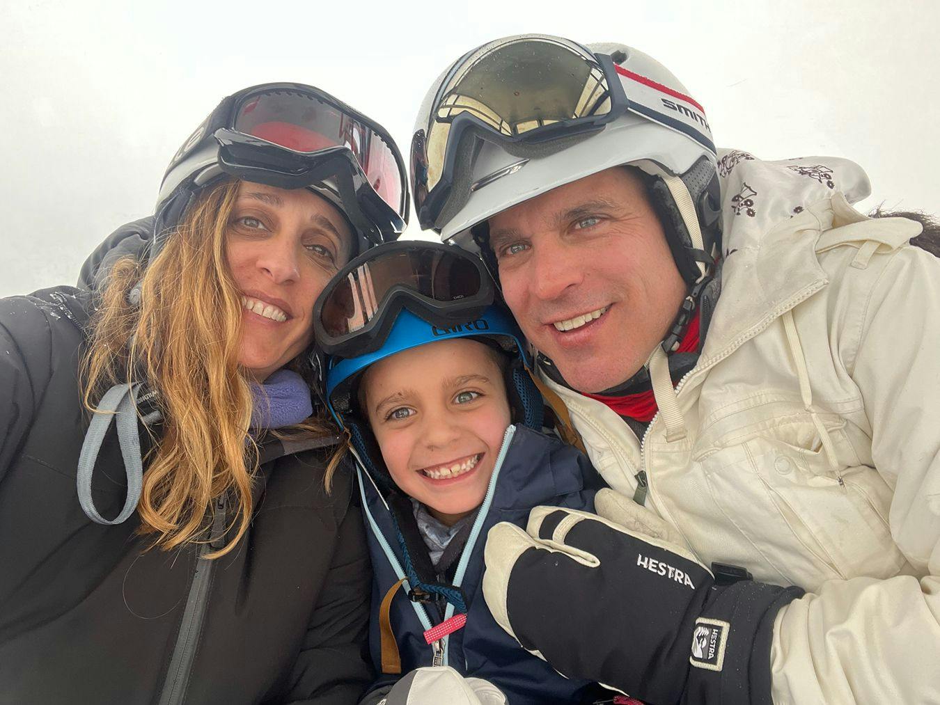 Eduardo Berlin and his family in skiing gear.