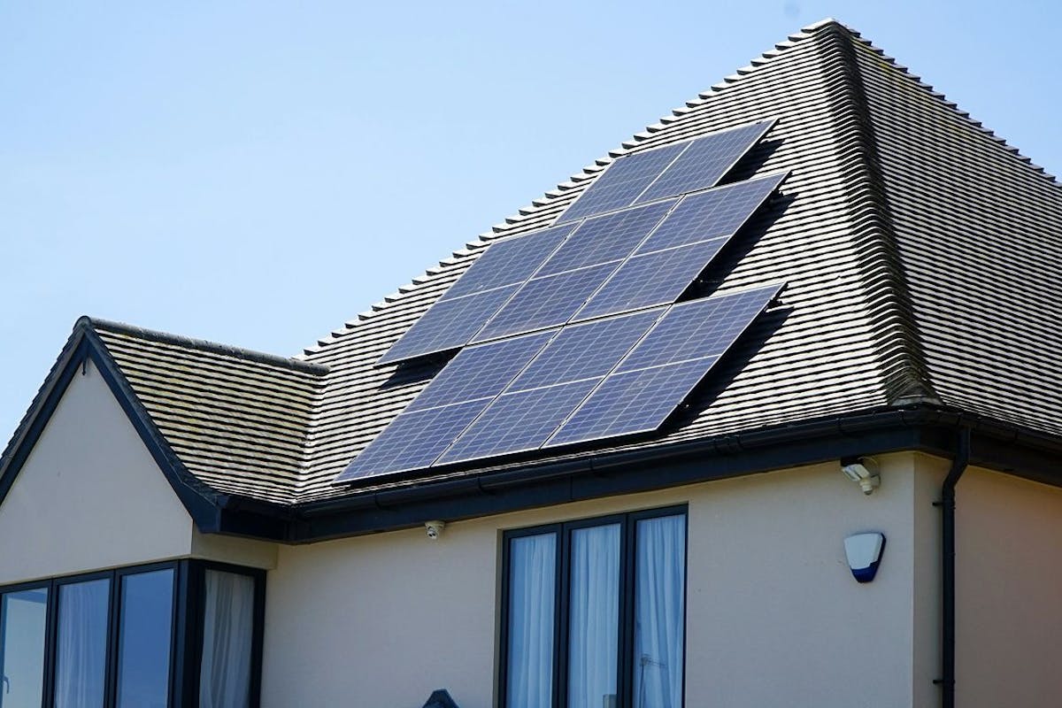 A house with solar panels on its roof.