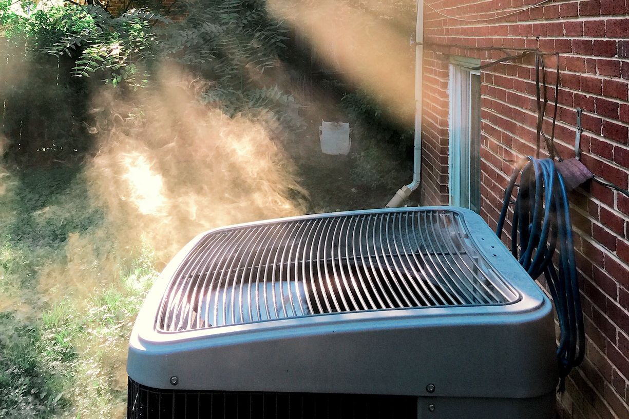 An outdoor air conditioning or heat pump unit on a cold morning.