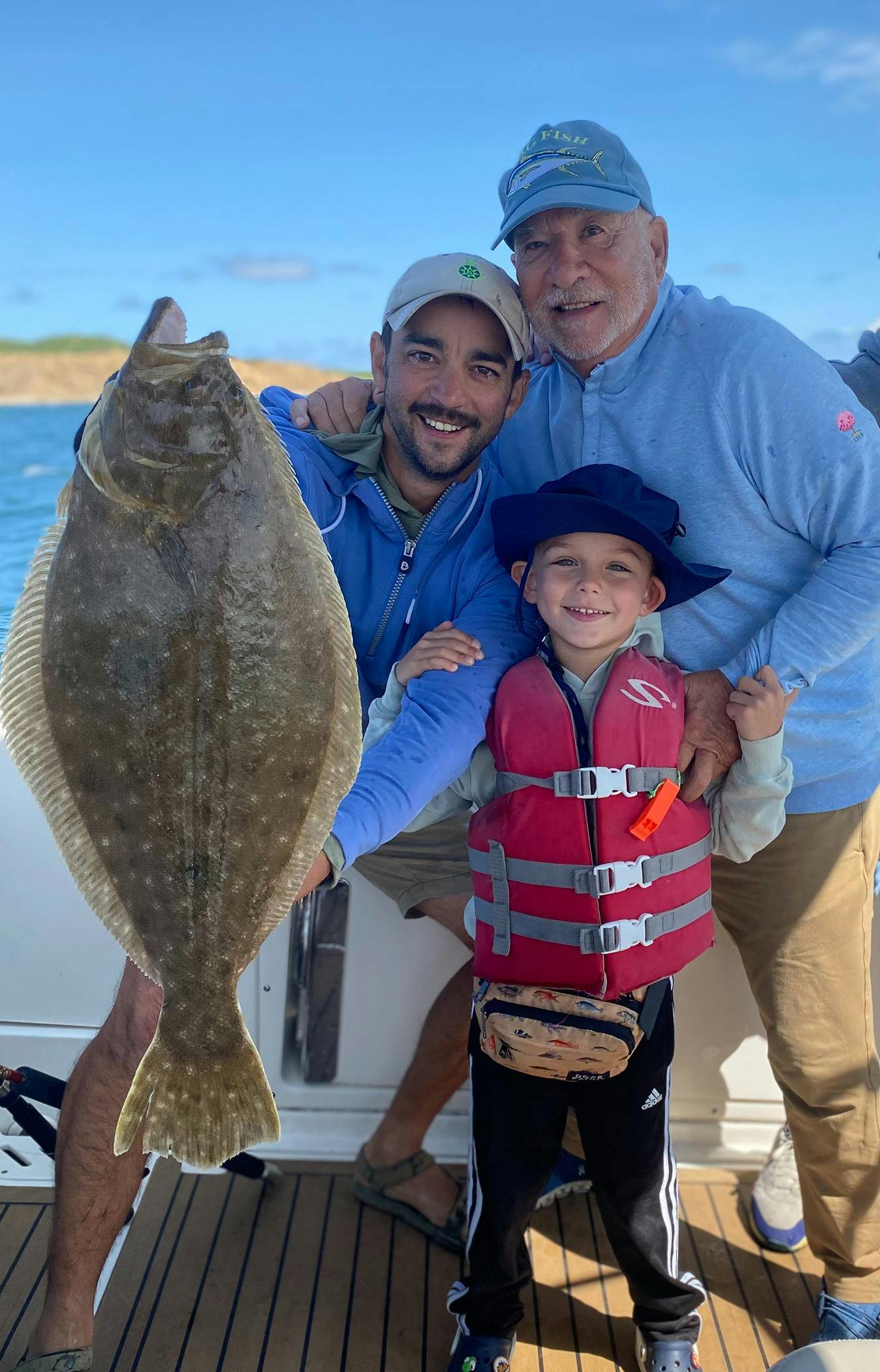 Ryan Barnett and family after catching a fish.