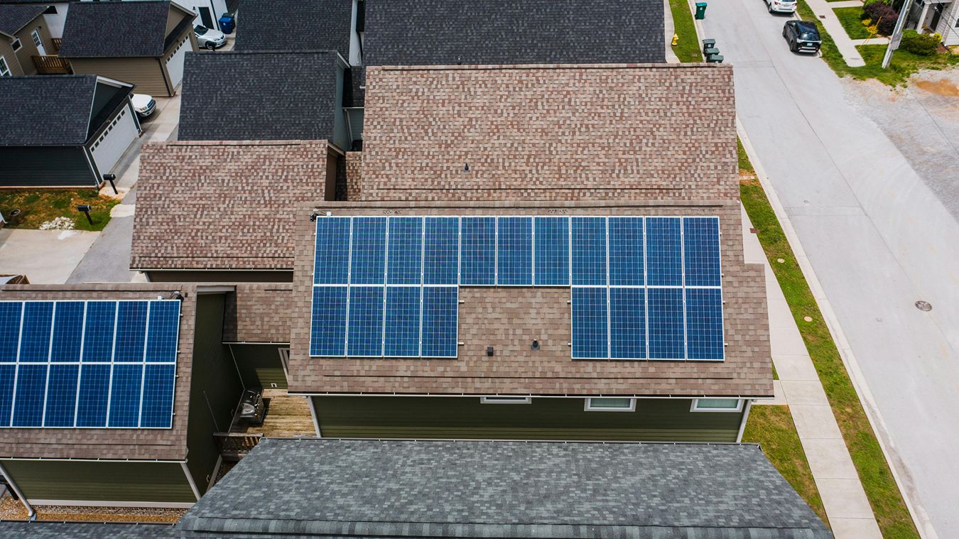 Solar panels on a house roof, seen from above.