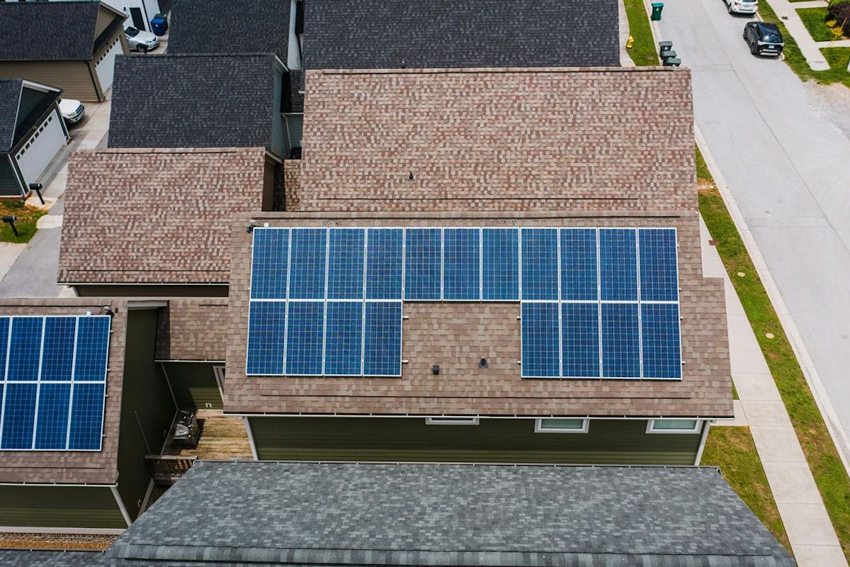 Solar panels on a house roof, seen from above.