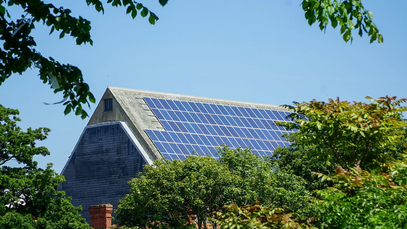 A large array of solar panels on a roof.