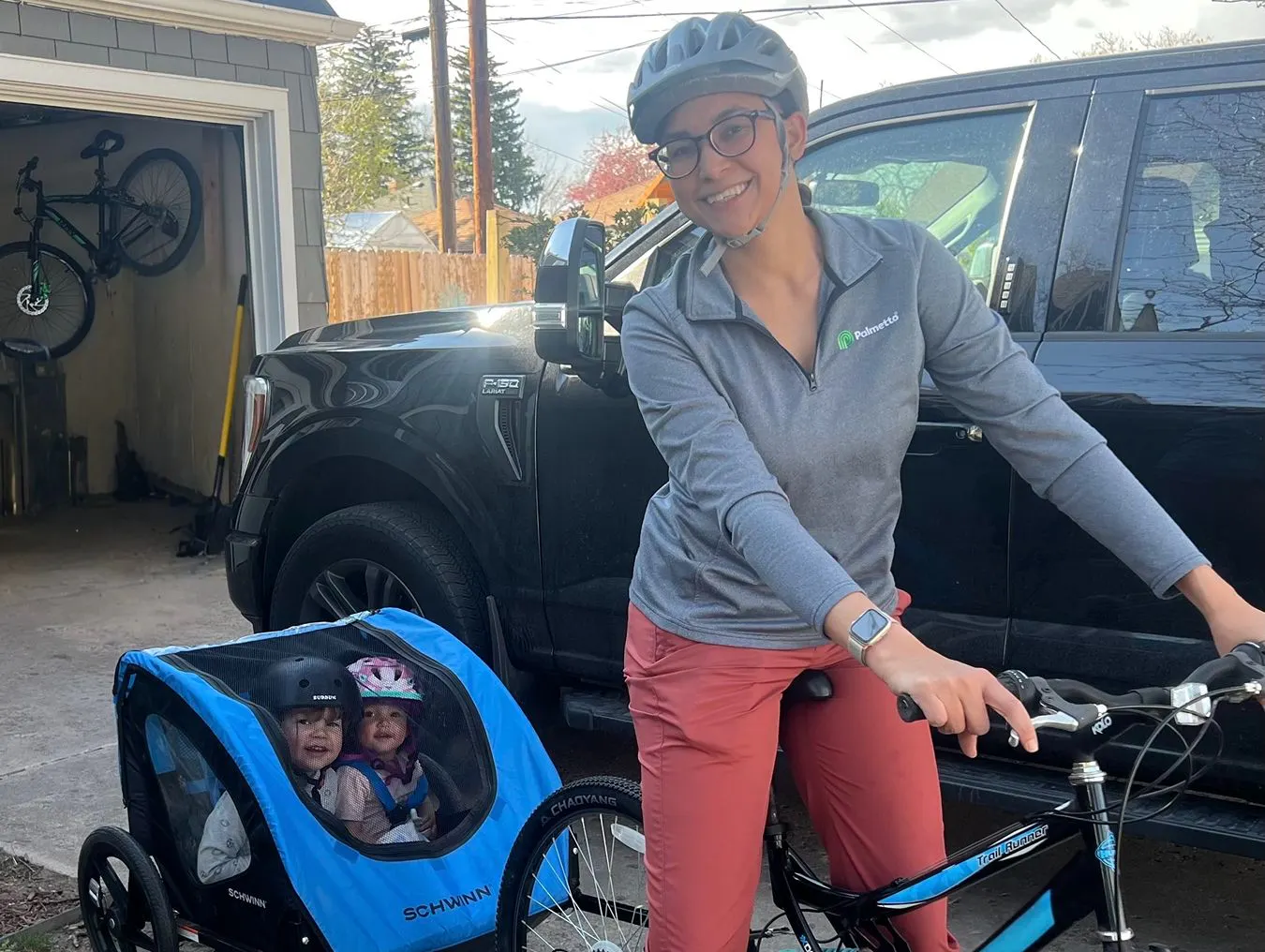 Kathryn Fincher biking with her two children.