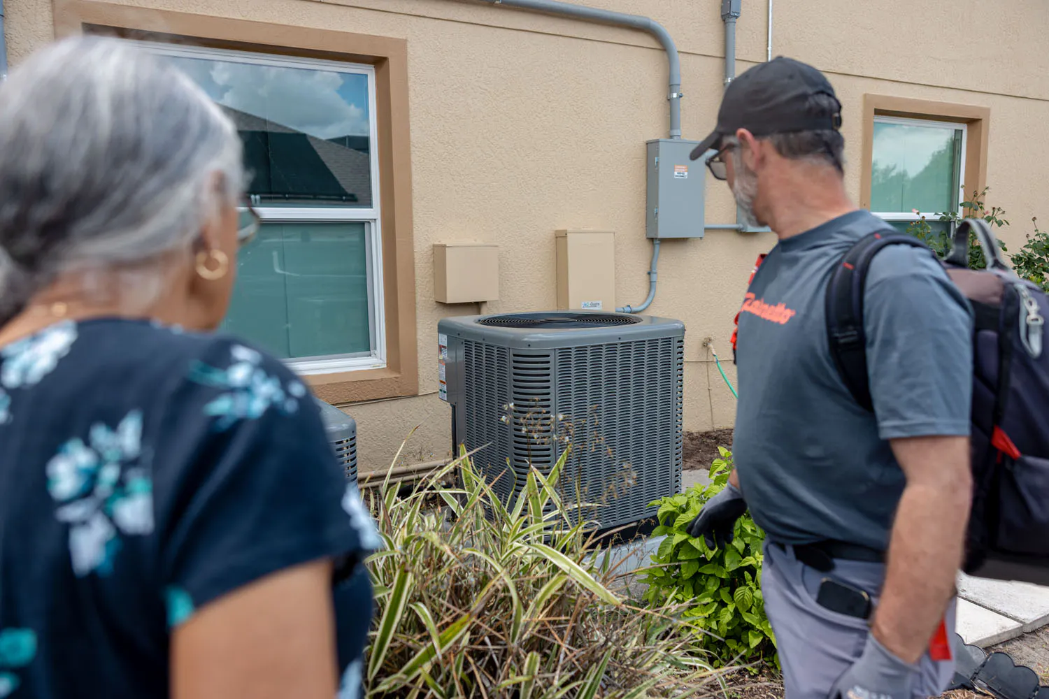 Geraldine and a Palmetto technician inspecting the heat pump.