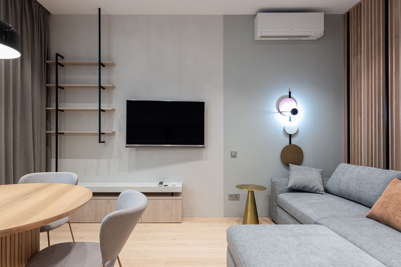 A mini-split air conditioning unit on the wall of a modern room.