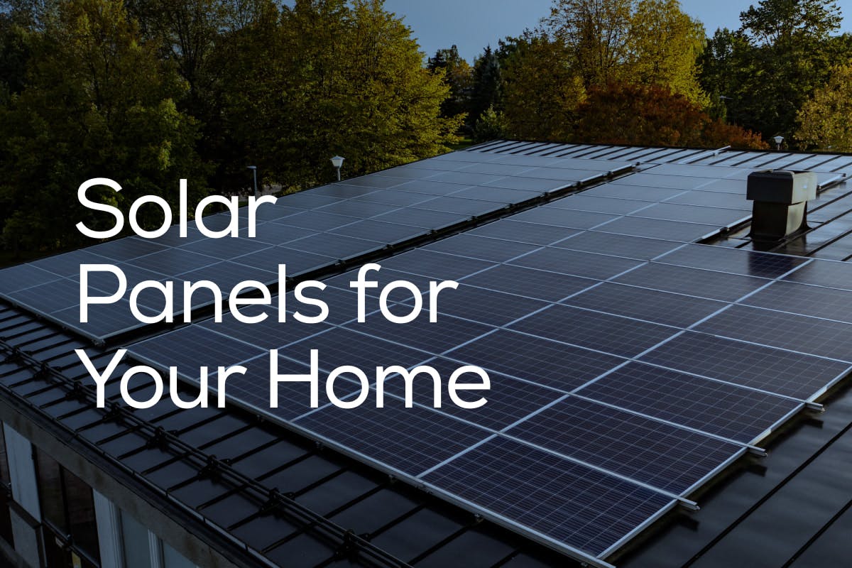 Solar panels installed in a dark metal roof, with the words "Solar Panels For Your Home" in white letters over top of the background image.