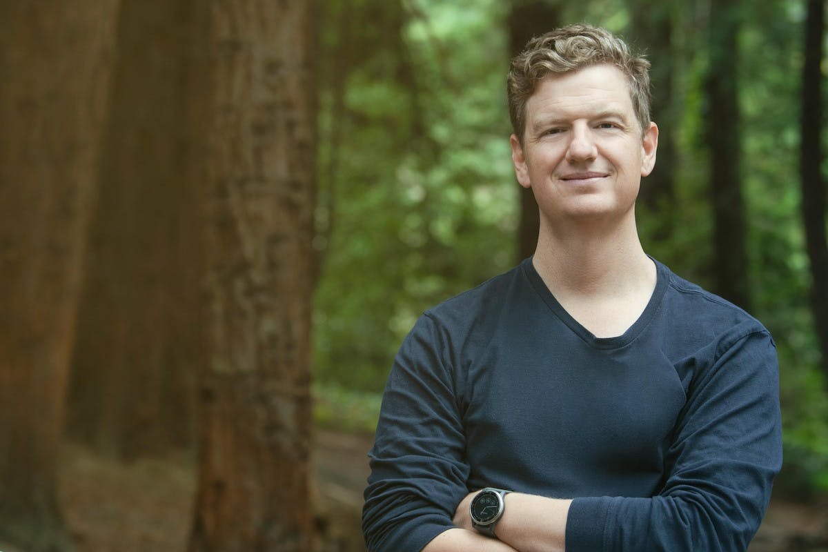 Head shot of Palmetto founder and CEO, Chris Kemper, in a wooded landscape.