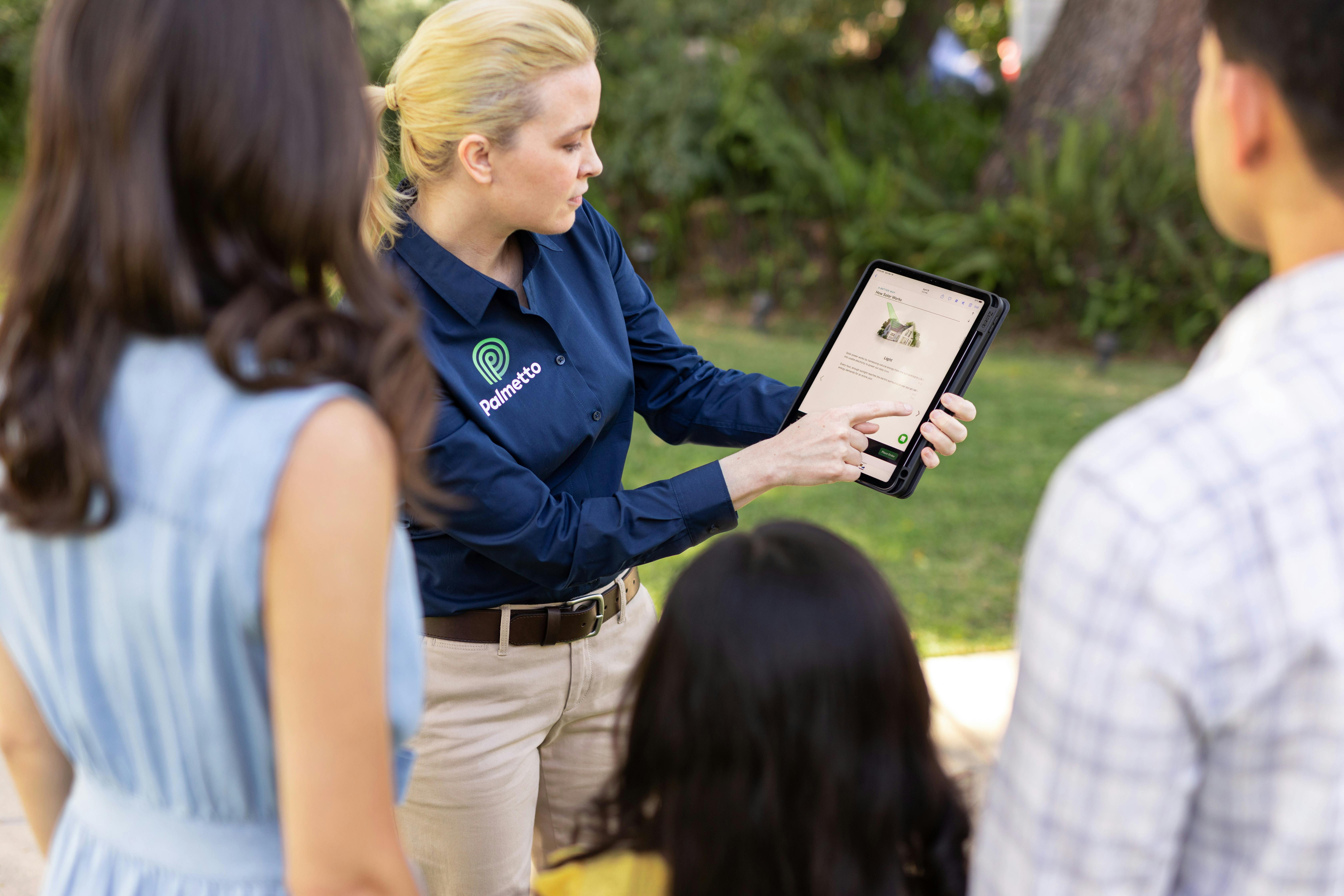 A Palmetto solar advisor speaks with a family.