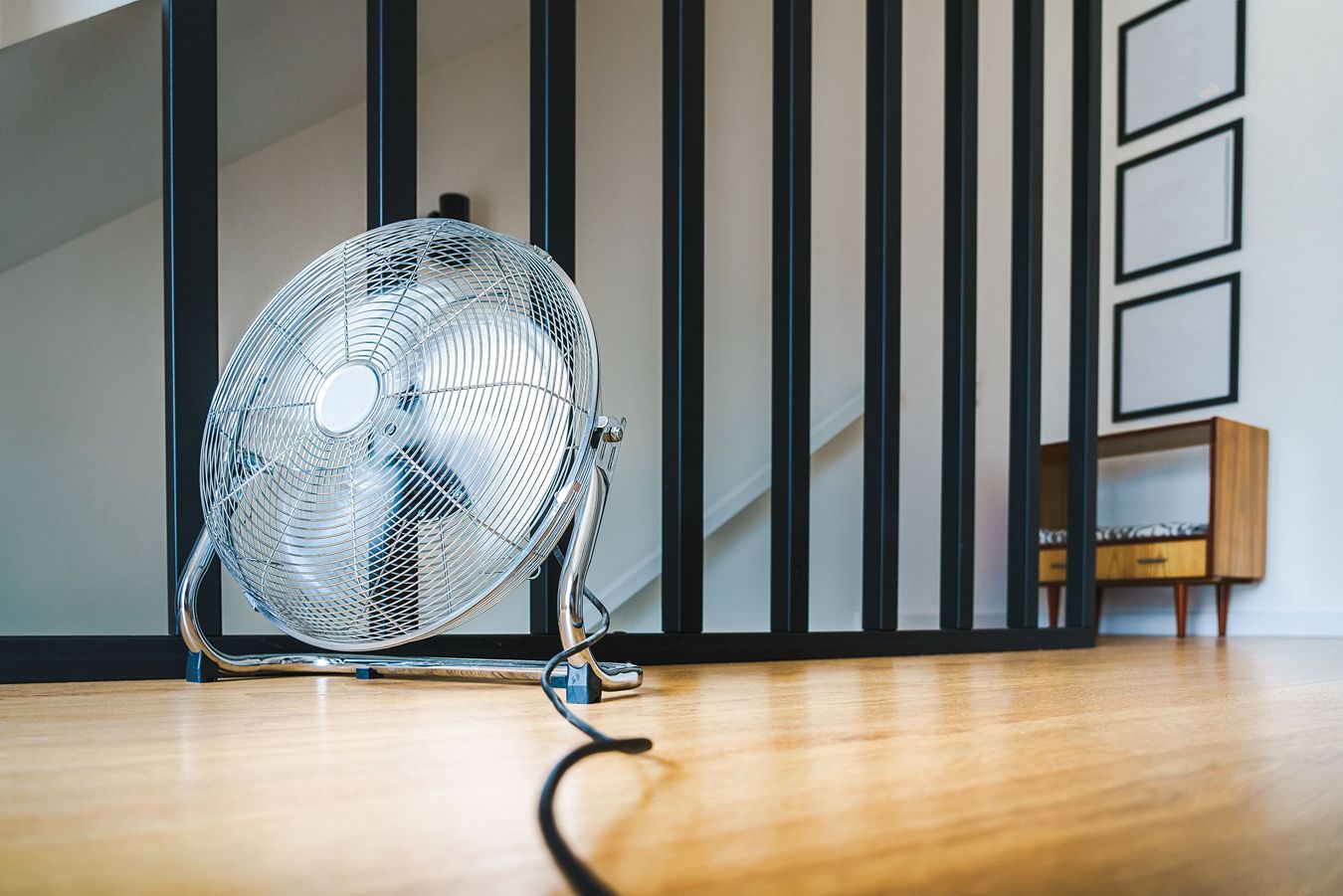 A wire-cage floor fan.