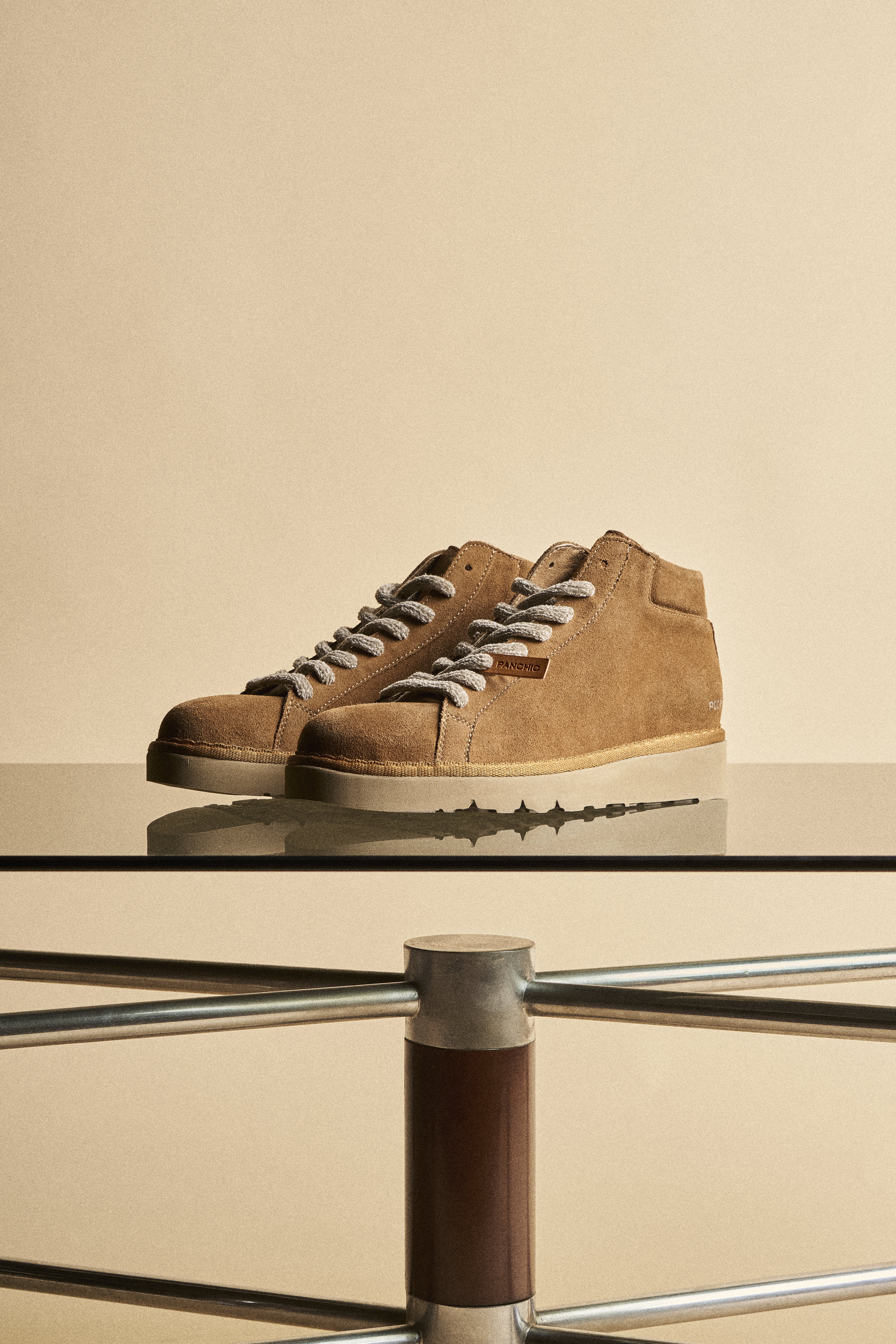 A pair of brown-sugar P007 on a glass table.