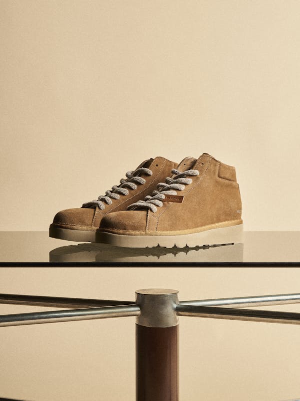 A pair of brown-sugar P007 on a glass table.