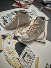 A pair of P007 is set on a stack of colourful prints.