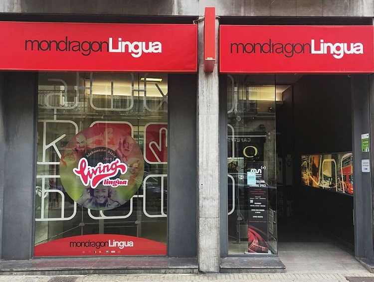 Fachada con cartel rojo del curso de ingl&eacute;s MondragonLingua en Vitoria-Gasteiz.