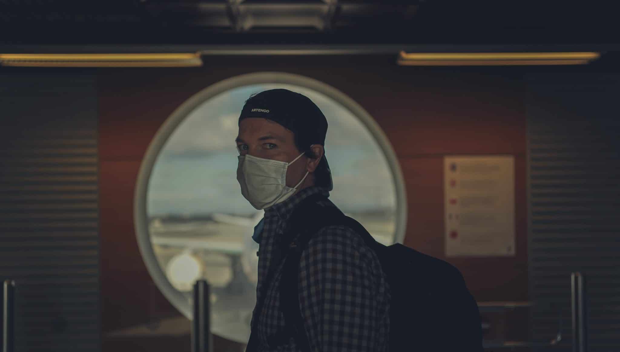 traveller wearing a mask at an airport