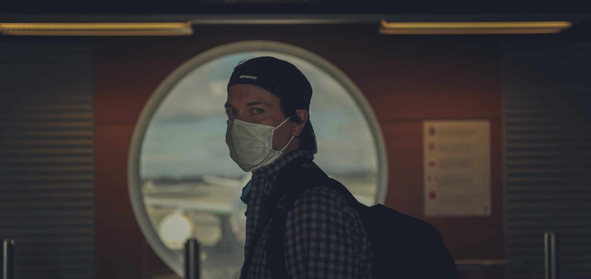 traveller wearing a mask at an airport