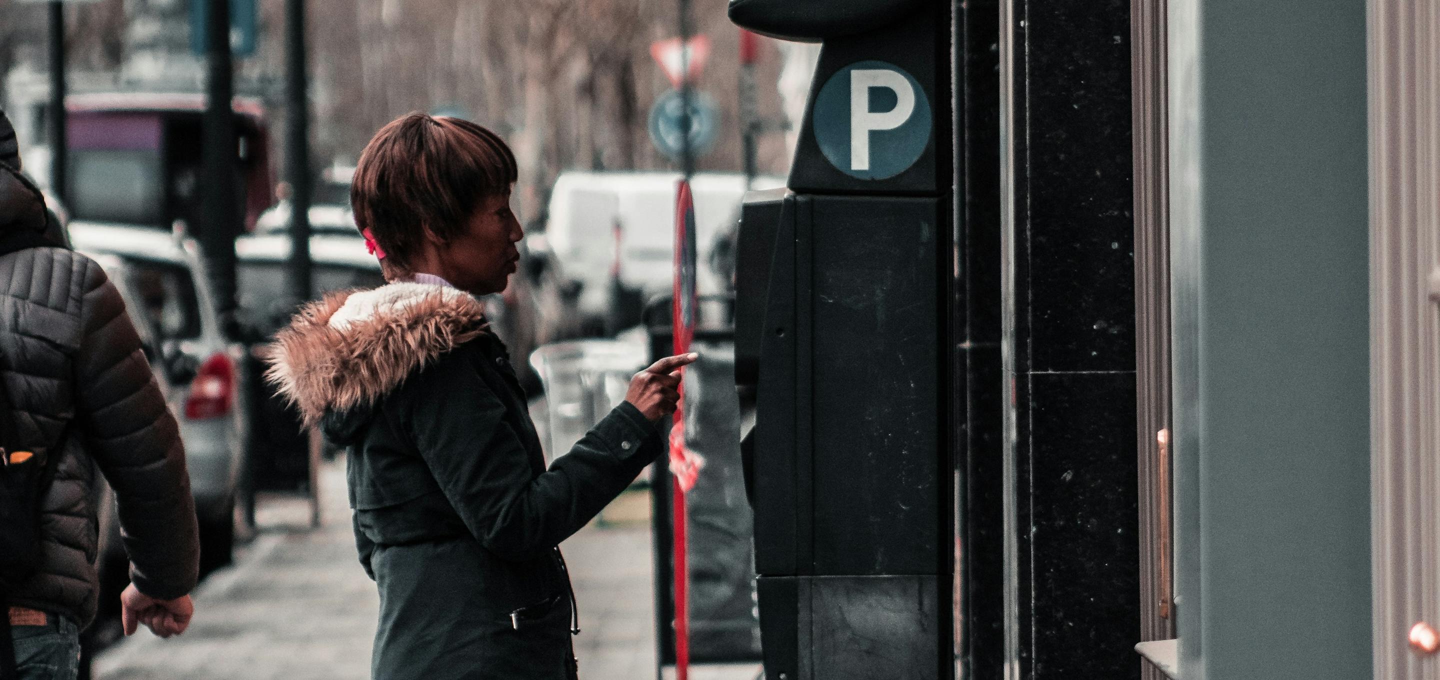 Motorist paying for parking at a meter